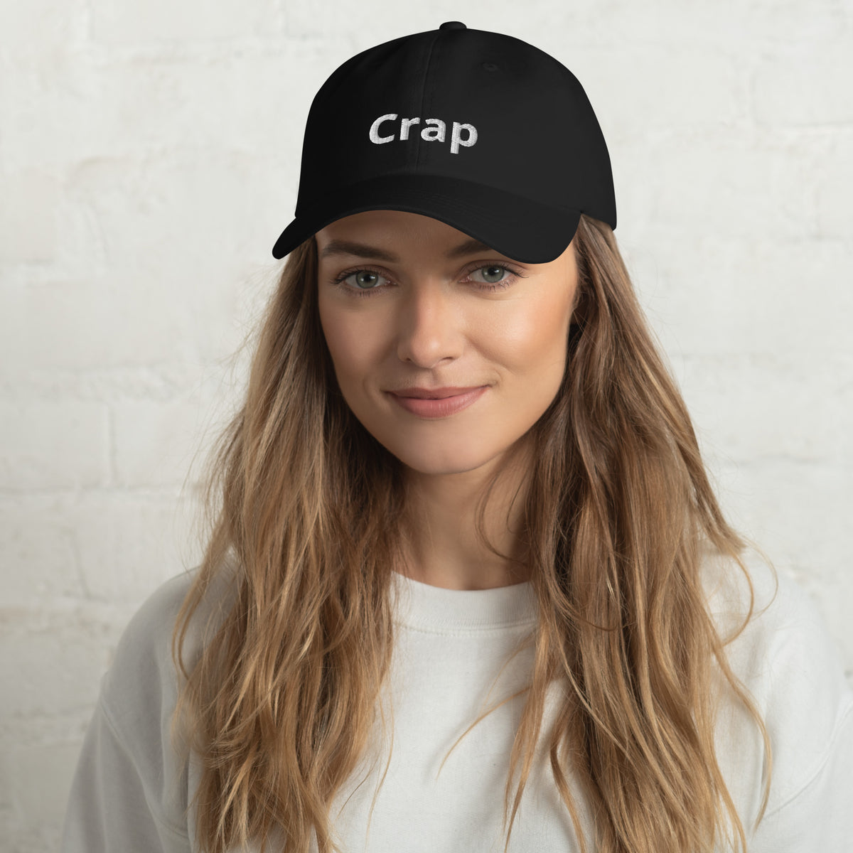 Woman wearing a black Crap dad hat