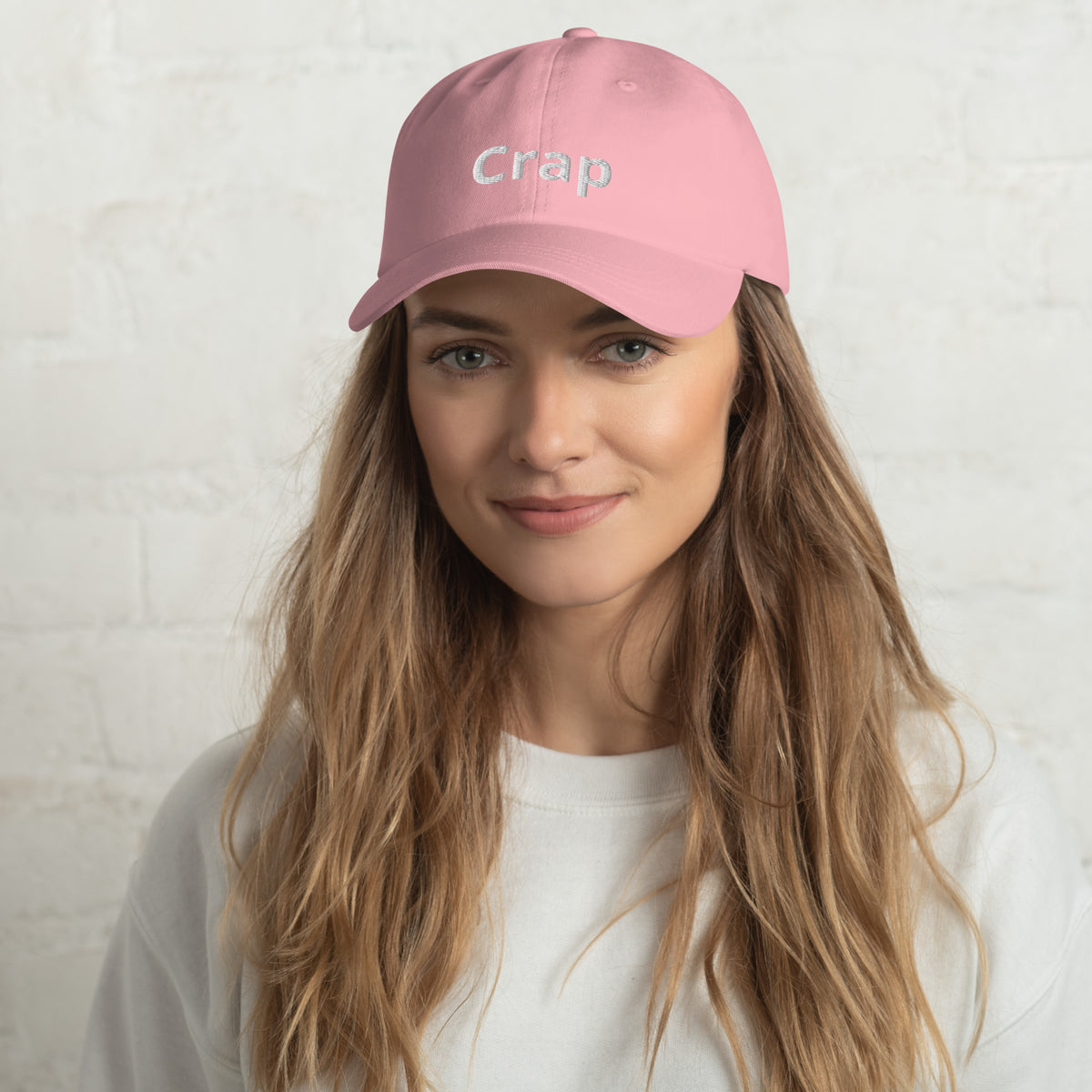 Woman wearing a pink Crap dad hat